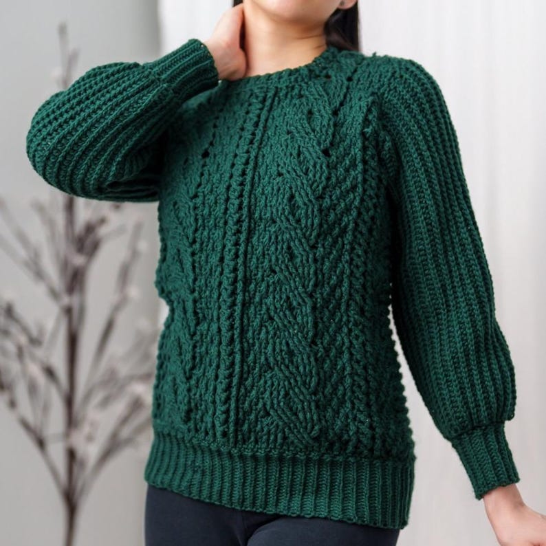 TCDDIY crochet pattern for a classic cropped crewneck sweater featuring cable and alpine stitches with ribbing details, made using Big Twist Soft yarn in Hunter Green.