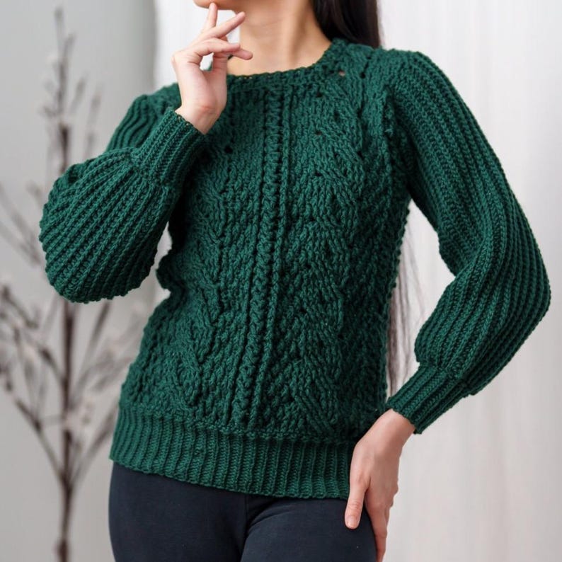 TCDDIY crochet pattern for a classic cropped crewneck sweater featuring cable and alpine stitches with ribbing details, made using Big Twist Soft yarn in Hunter Green.
