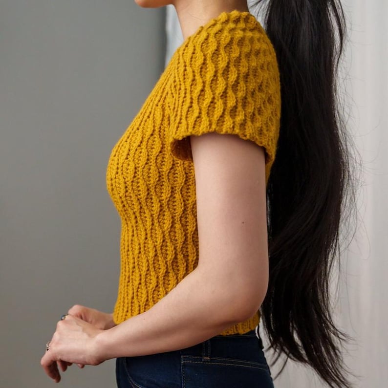 TCDDIY crochet pattern for a modern short sleeve crew neck t-shirt with almond stitch detail, crafted using Lion Brand Pound of Love yarn in Maize, side view.