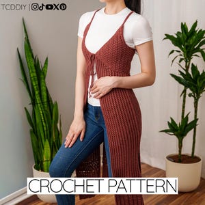 Pode incluir: Um colete de crochê cor de ferrugem com fecho de laço, usado sobre uma camiseta branca e jeans azuis. O colete tem um design longo e aberto. O texto "CROCHET PATTERN" é exibido na parte inferior da imagem.
