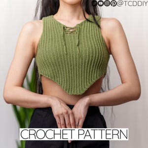 May include: A green crochet top with a lace-up neckline and a unique triangular hemline. The top is made of a textured, knitted material. The words "CROCHET PATTERN" are displayed in white text at the bottom of the image.