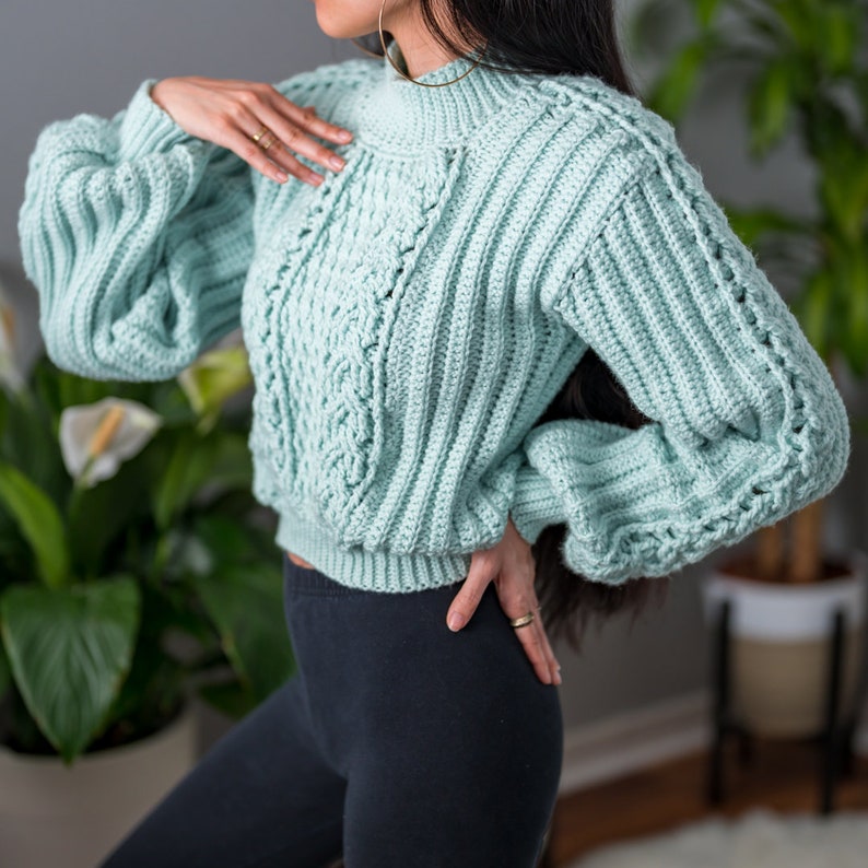 TCDDIY crochet pattern for a cropped cable stitch sweater with a mock neck and alpine stitch detailing, crafted using Caron One Pound yarn in Pale Green.