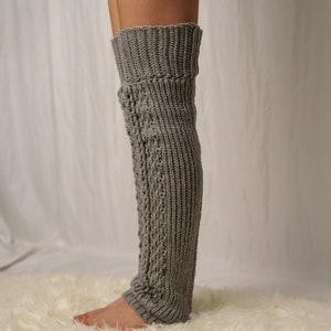 TCDDIY crochet pattern for Cable Stitch Leg Warmers featuring Alpine stitch detail and a knee-high fit, crafted using Caron One Pound yarn in Soft Grey Mix, side view.