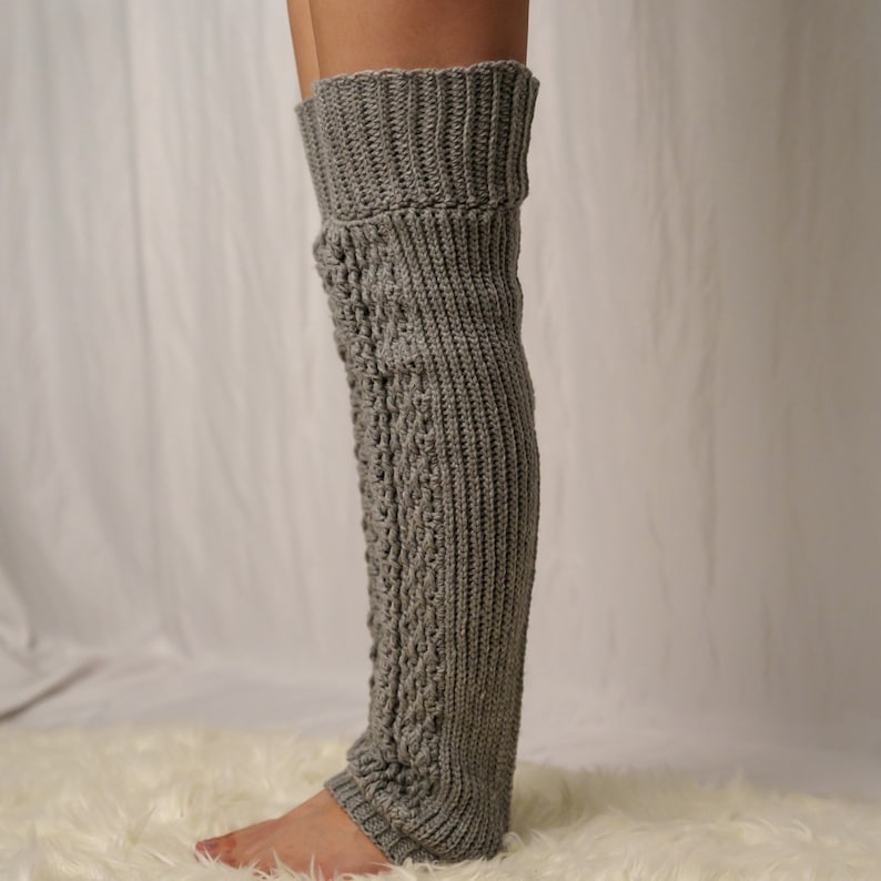 TCDDIY crochet pattern for Cable Stitch Leg Warmers featuring Alpine stitch detail and a knee-high fit, crafted using Caron One Pound yarn in Soft Grey Mix, side view.