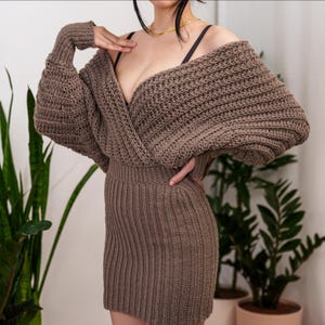 TCDDIY crochet pattern for a batwing wrap sweater dress with ribbed cuffs and fitted skirt, crafted with Lion Brand Pound of Love in Taupe.