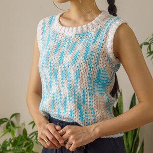 TCDDIY crochet pattern for an easy moss stitch tank top with a slouchy fit, beginner-friendly, crafted using Bernat Baby Sport yarn in Popsicle Blue and White.