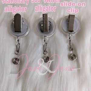 May include: Three clear plastic badge holders with a swivel alligator clip and a stationary alligator clip. The clips are silver metal.