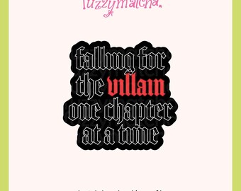 May include: A black sticker with white gothic-style lettering that reads falling for the villain one chapter at a time, with the word villain highlighted in red. The text is arranged in a block shape with a thick black outline against a light background.
