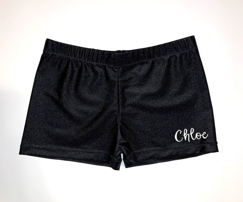 May include: Black athletic shorts with the name "Chloe" embroidered in white on the right leg.