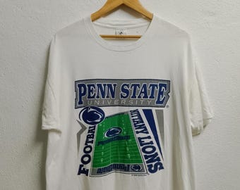 May include: White t-shirt with a blue and gray graphic of a football field and the text "Penn State University Football Nittany Lions".