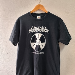 May include: Black t-shirt with a white graphic featuring a skull inside a radiation symbol, with the text "ENEMY OF JESUS" below. The shirt also has the band name "ABSOLUTE CHAOS" in a stylized font.