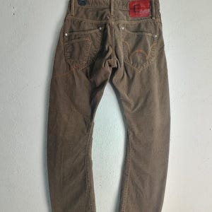 May include: A set of three ceramic mugs with a speckled, matte finish in cream, light grey, and dark grey. Each mug has a simple, minimalist design, suitable for coffee or tea.