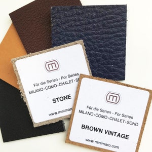 May include: Four leather swatches in different colors: brown, tan, dark blue, and black. Each swatch has a small label with the text "Für die Serien - For Series" and the name of the color: "Stone", "Brown Vintage", "Milano Como Chalet Soho", and "Milano Como Chalet". The labels also include the website address "www.minimaro.com".