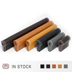 Può includere: Sei tiretti per cassetti in pelle di diversi colori, tra cui nero, marrone, beige e grigio. I tiretti hanno un bordo cucito e sono in stock.