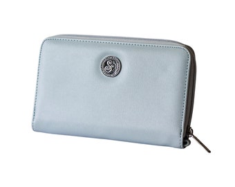 May include: A light blue zippered wallet with a silver circular logo featuring a stylised letter "S".