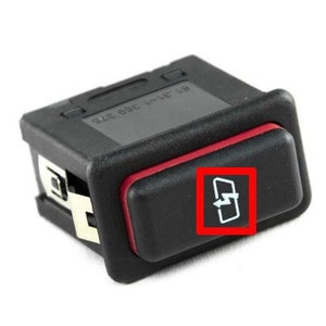 May include: Black plastic switch with a red trim and a white lightning bolt icon inside a square. The switch is labelled "911 606 372".