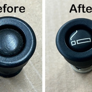 May include: Before and after cleaning a black car cigarette lighter. The lighter has a white symbol of a cigarette with smoke coming out of it.
