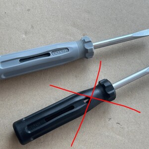 May include: Two screwdrivers with black and gray handles. The gray screwdriver has the word "HEYCO" printed on the handle. The black screwdriver has the word "WIRTH" printed on the handle.