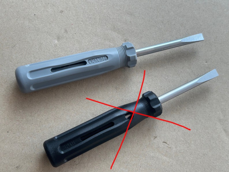 May include: Two screwdrivers with black and gray handles. The gray screwdriver has the word "HEYCO" printed on the handle. The black screwdriver has the word "WIRTH" printed on the handle.