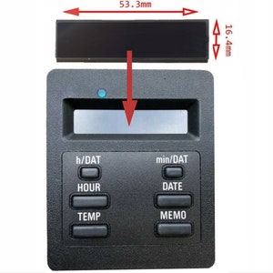 May include: Black digital clock with a rectangular LCD display and five buttons labeled "h/DAT", "HOUR", "TEMP", "min/DAT", "DATE", and "MEMO". The clock measures 5.3 cm wide and 1.6 cm high.