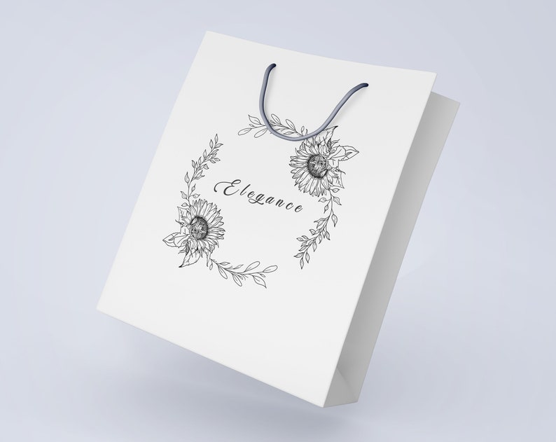 May include: White paper shopping bag with a black ink illustration of a floral wreath featuring sunflowers and the word "Elegance" in cursive.