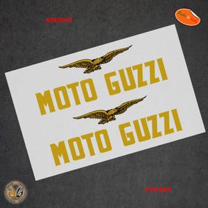 Peut inclure: Deux autocollants d'aigle dorés avec le texte "Moto Guzzi" imprimé en or sur fond blanc. Les autocollants sont destinés à être utilisés sur des motos ou d'autres véhicules.