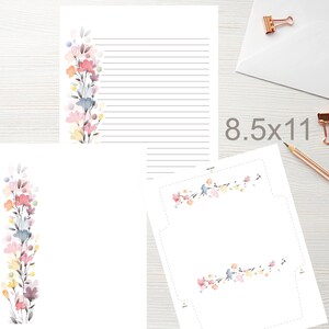 May include: White stationery set with floral watercolor design. Includes lined paper, blank paper, and an envelope. The paper size is 8.5 x 11 inches. The floral design features pink, blue, yellow, and purple flowers.