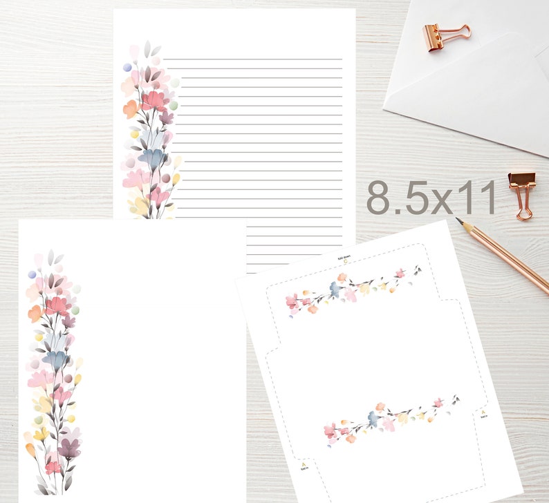 May include: White stationery set with floral watercolor design. Includes lined paper, blank paper, and an envelope. The paper size is 8.5 x 11 inches. The floral design features pink, blue, yellow, and purple flowers.