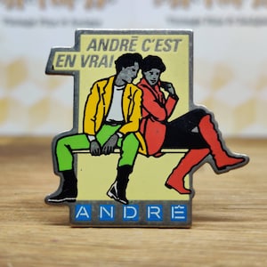 Andre french fashion pin badge. Hat Tie Lapel bag denim or leather jacket. Vintage retro collectable advertising collectable gift.