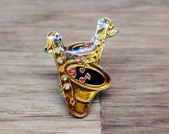 Duelling saxophone enamel pin badge.