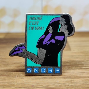 Andre french fashion pin badge. Hat Tie Lapel bag denim or leather jacket. Vintage retro collectable advertising collectable gift.