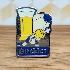 Buckler beer pin badge. Hat Tie Lapel scarf bag denim or leather rugby League team. Vintage retro collectable advertising gift pub bar