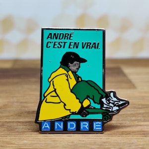 Andre french fashion pin badge. Hat Tie Lapel bag denim or leather jacket. Vintage retro collectable advertising collectable gift.
