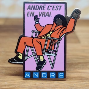 Andre french fashion pin badge. Hat Tie Lapel bag denim or leather jacket. Vintage retro collectable advertising collectable gift.
