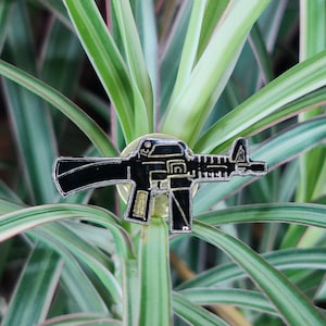 Machinegun vintage enamel lapel pin.