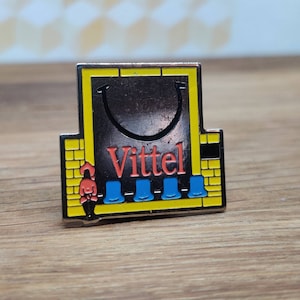 Vittel bottled water enamel pin badge. Vintage retro collectable advertising gift. Hat Tie Lapel scarf bag denim leather jacket accessorie