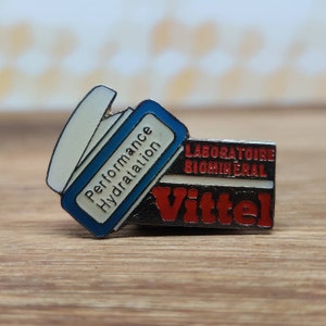 Vittel bottled water enamel pin badge. Vintage retro collectable advertising gift. Hat Tie Lapel scarf bag denim leather jacket accessorie