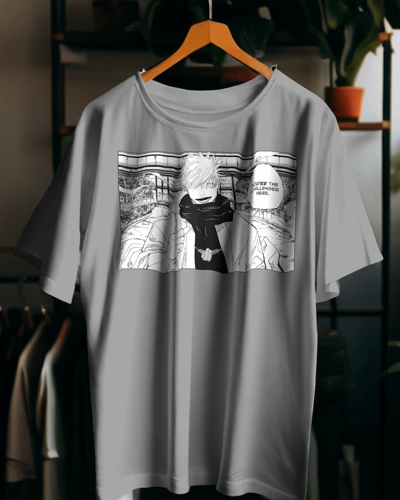 May include: Gray t-shirt with a black and white manga-style illustration of a character with spiky blonde hair and the text "You're the Challenger Here."