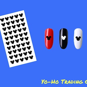 May include: A sheet of black Mickey Mouse head nail art stickers next to three painted fingernails. The fingernails are red, black, and white, each with a Mickey Mouse head design. The background is blue, and the text "YO-HO TRADING CO." is at the bottom.