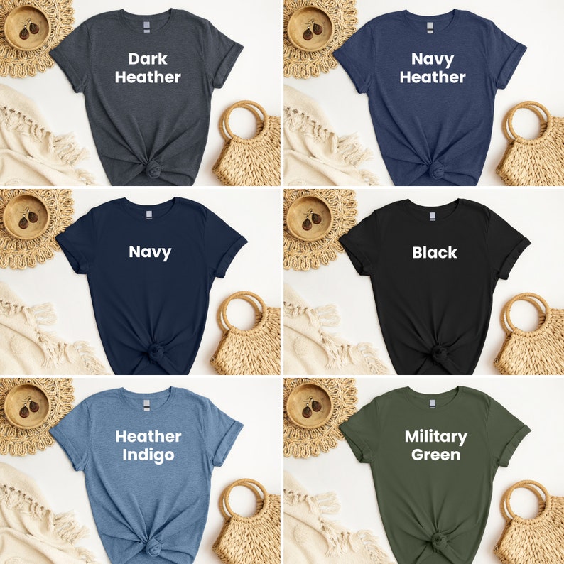 May include: Six different color t-shirts with a white text design. The colors are dark heather, navy heather, navy, black, heather indigo, and military green. The text on the shirts reads "Dark Heather", "Navy Heather", "Navy", "Black", "Heather Indigo", and "Military Green".