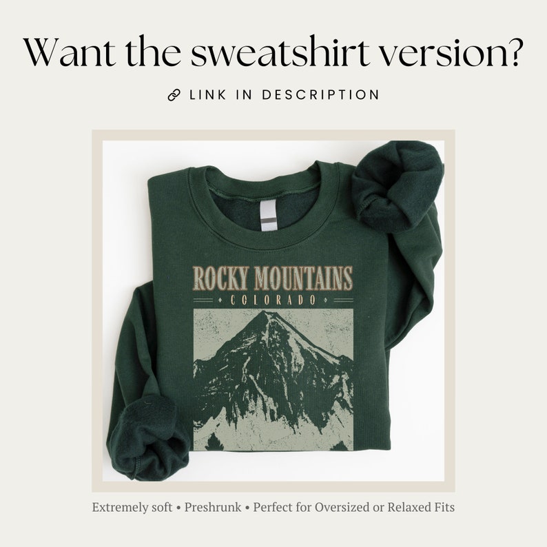 May include: A dark green sweatshirt with the text "ROCKY MOUNTAINS &bull; COLORADO &bull;" and a graphic of a mountain range. The sweatshirt is folded and has a relaxed fit.
