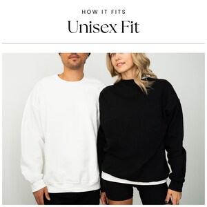 May include: Two people wearing sweatshirts, one white and one black, with the text "Unisex Fit" above them.