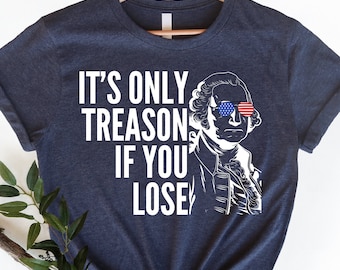 May include: Navy blue t-shirt with the text "IT'S ONLY TREASON IF YOU LOSE" in white. The shirt features a black and white illustration of a historical figure wearing sunglasses with an American flag design.