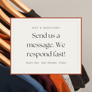 May include: A white card with a brown border, with the text "GOT A QUESTION? Send us a message. We respond fast! Hours: 9am - 5pm | Monday - Friday" on a gray background. The card is in front of a rack of colorful t-shirts.