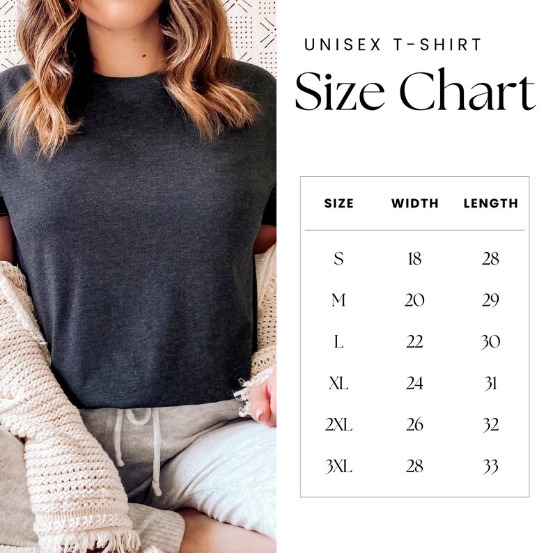 May include: A dark gray unisex t-shirt with a size chart. The size chart lists sizes S through 3XL, with corresponding width and length measurements in inches. The shirt is displayed on a person wearing a cream-colored cardigan and gray sweatpants.