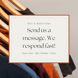 Pu&ograve; includere: Un rettangolo bianco con angoli arrotondati e un bordo marrone contiene testo che dice "GOT A QUESTION? Send us a message. We respond fast! Hours: 9am - 5pm | Monday - Friday". Il rettangolo &egrave; davanti a un rack di magliette colorate appese a grucce di legno.