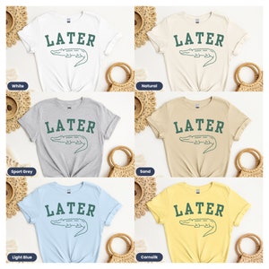 May include: Five different color t-shirts with the text "LATER" and a green alligator graphic. The colors are white, natural, sport grey, sand, and light blue.