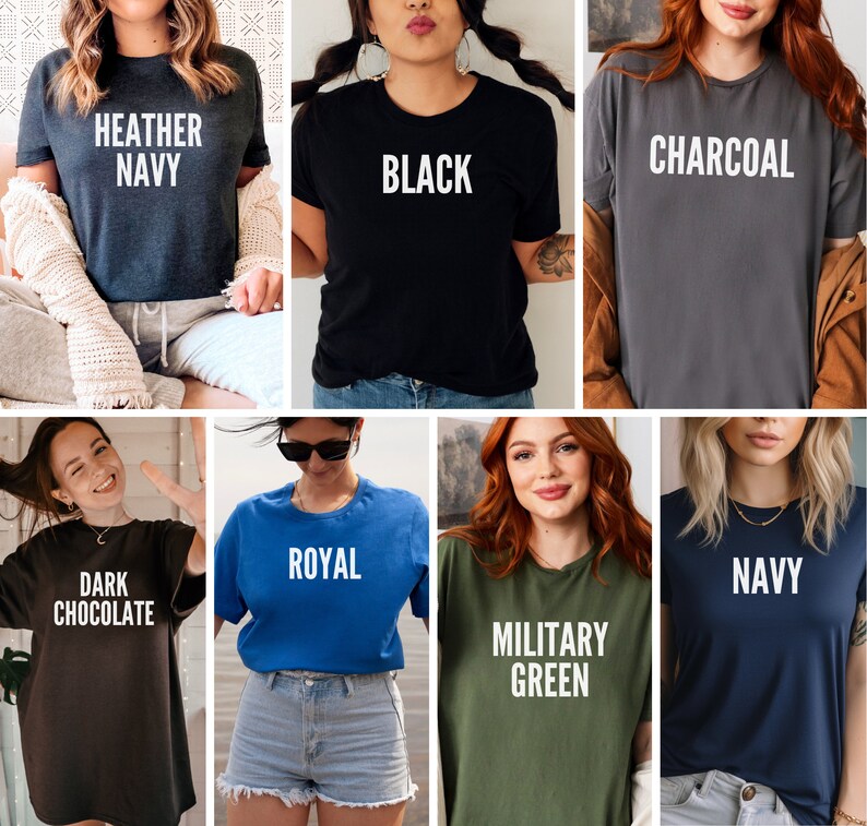 May include: A collection of t-shirts in various colors, each with a different color name printed in white. Colors include heather navy, black, charcoal, dark chocolate, royal, military green, and navy. The shirts are all short-sleeved and appear to be made of a soft material.