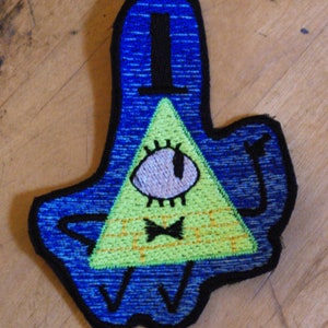 May include: A yellow triangle with a single eye and a black bow tie, surrounded by a blue outline. The triangle is standing on two legs and has two arms outstretched. The image is a cartoon character.