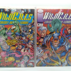 May include: Two comic books, WildC.A.T.S. Covert Action Teams, issue #3 and #4. The covers feature colorful illustrations of superheroes in action. Issue #3 features a green superhero with a purple suit and a red superhero with a yellow suit. Issue #4 features a blue superhero with a red suit and a red superhero with a yellow suit.